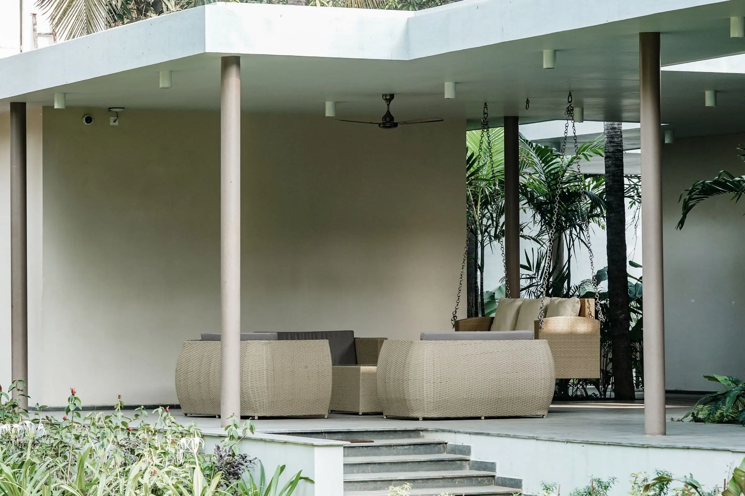 Modern flat patio cover on slim posts over outdoor sofas